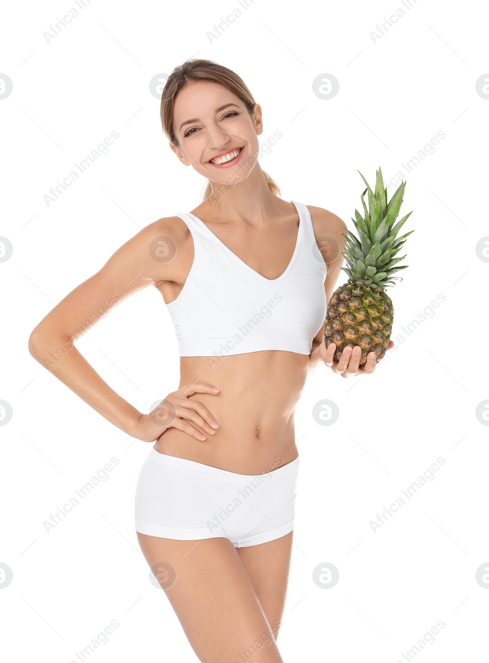 Photo of Happy slim woman in underwear holding pineapple on white background. Weight loss diet