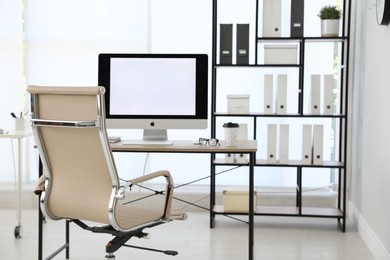 Photo of Modern workplace with comfortable chair in stylish office interior