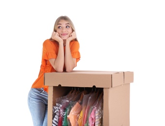 Photo of Young woman near wardrobe box on white background