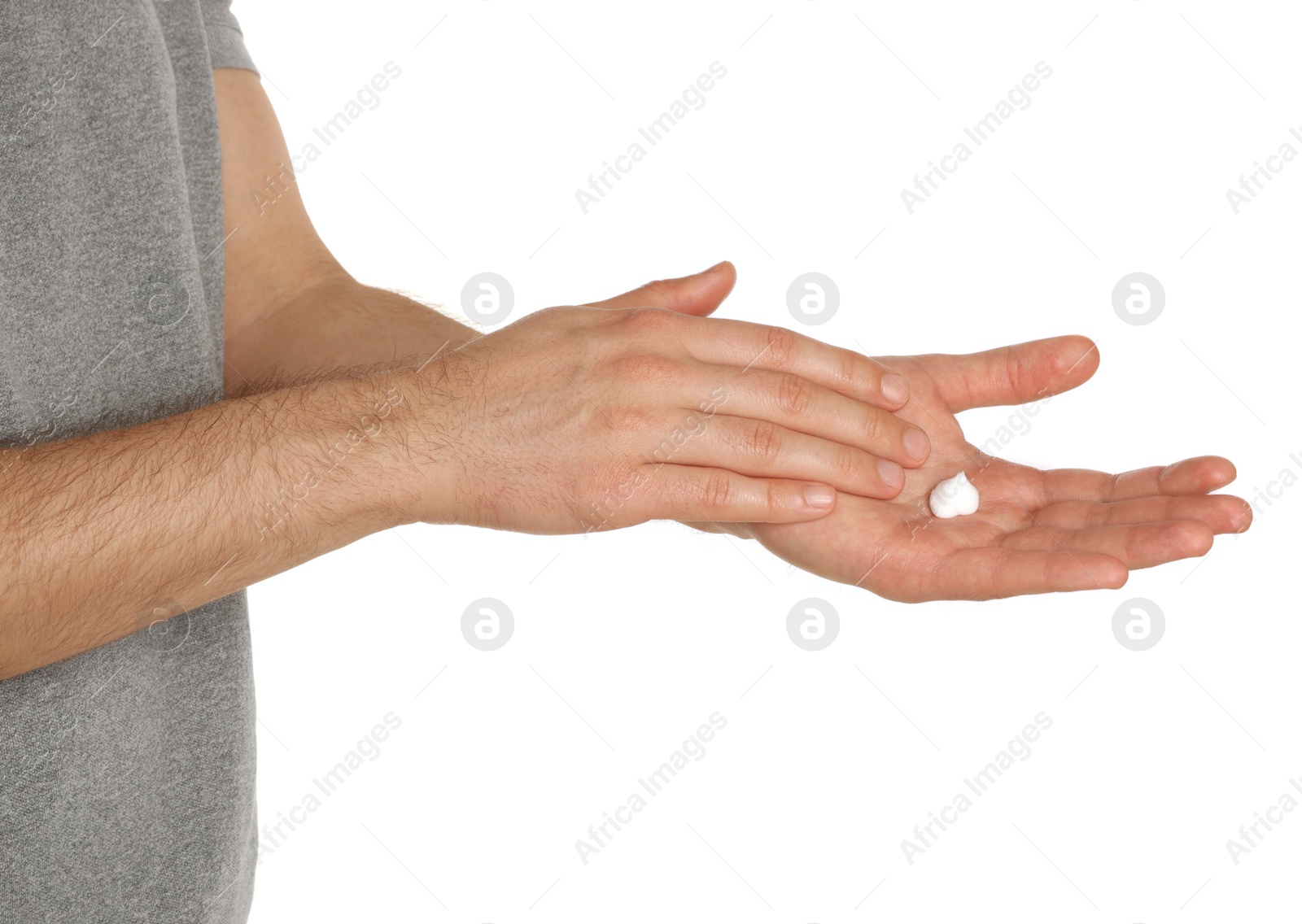 Photo of Man applying cream onto hand against white background, closeup