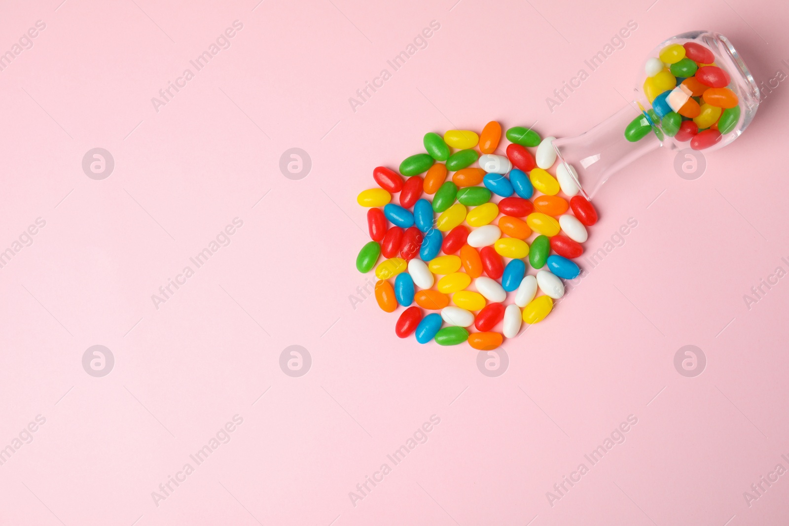 Photo of Flat lay composition with jelly beans on color background. Space for text