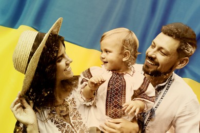 Image of Double exposure of happy family wearing national clothes and Ukrainian flag