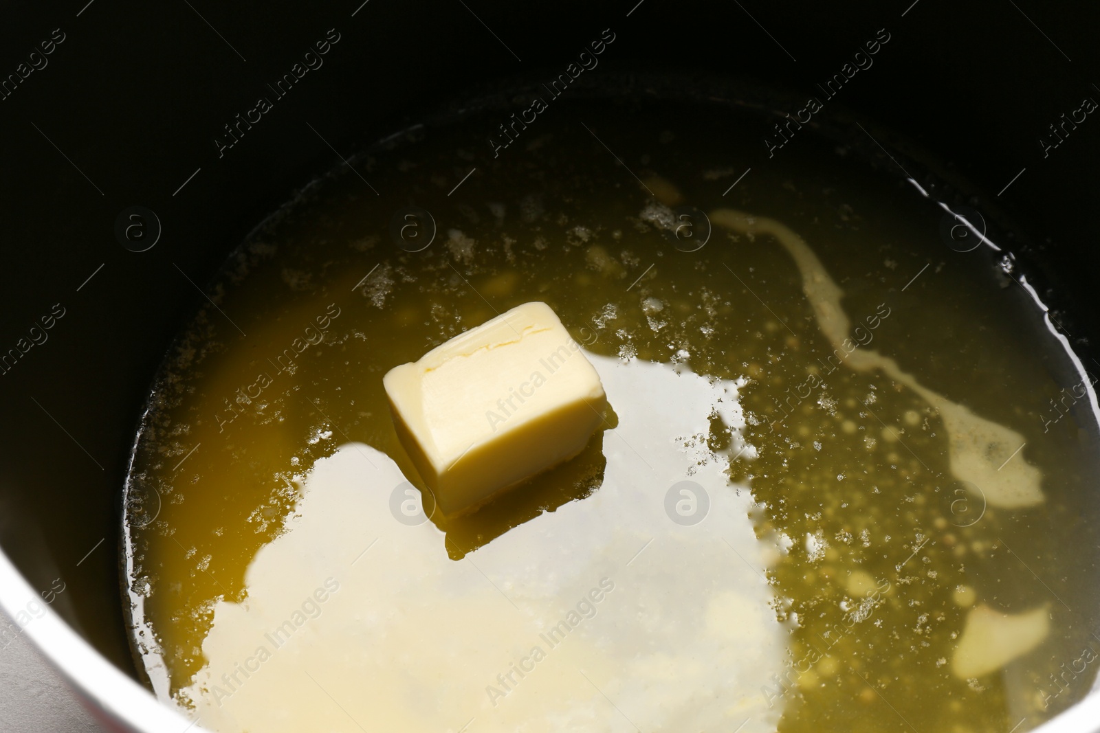Photo of Pot with tasty melting butter, closeup view
