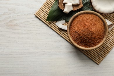 Photo of Flat lay composition with natural coconut sugar on white wooden table, space for text