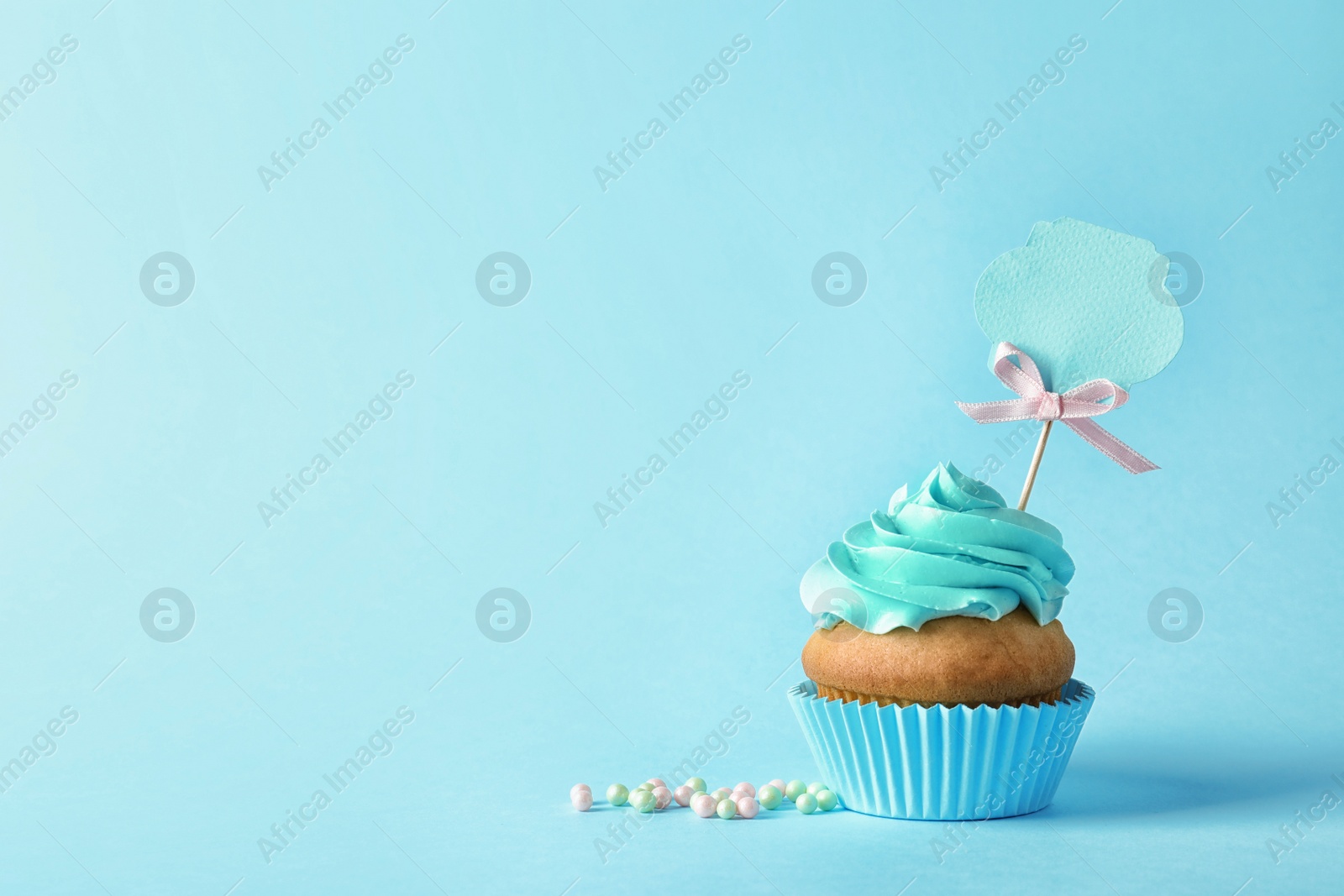 Photo of Delicious birthday cupcake and space for text on color background