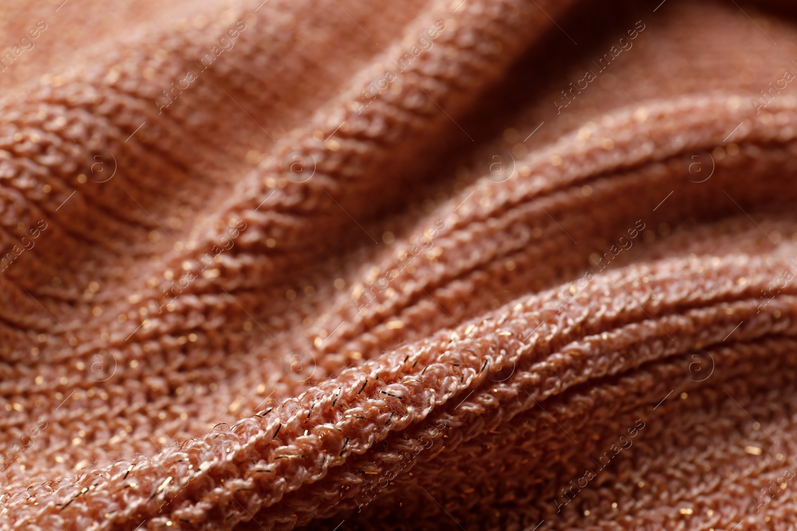 Photo of Brown knitted fabric as background, closeup view