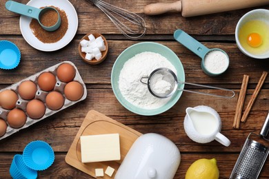 Photo of Cooking utensils and ingredients on wooden table, flat lay