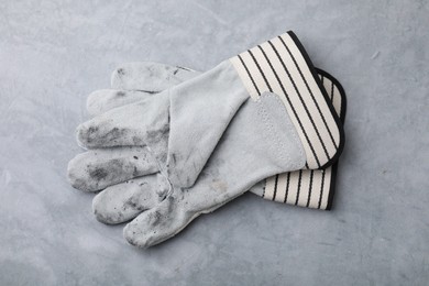 Pair of color gardening gloves on light grey table, top view