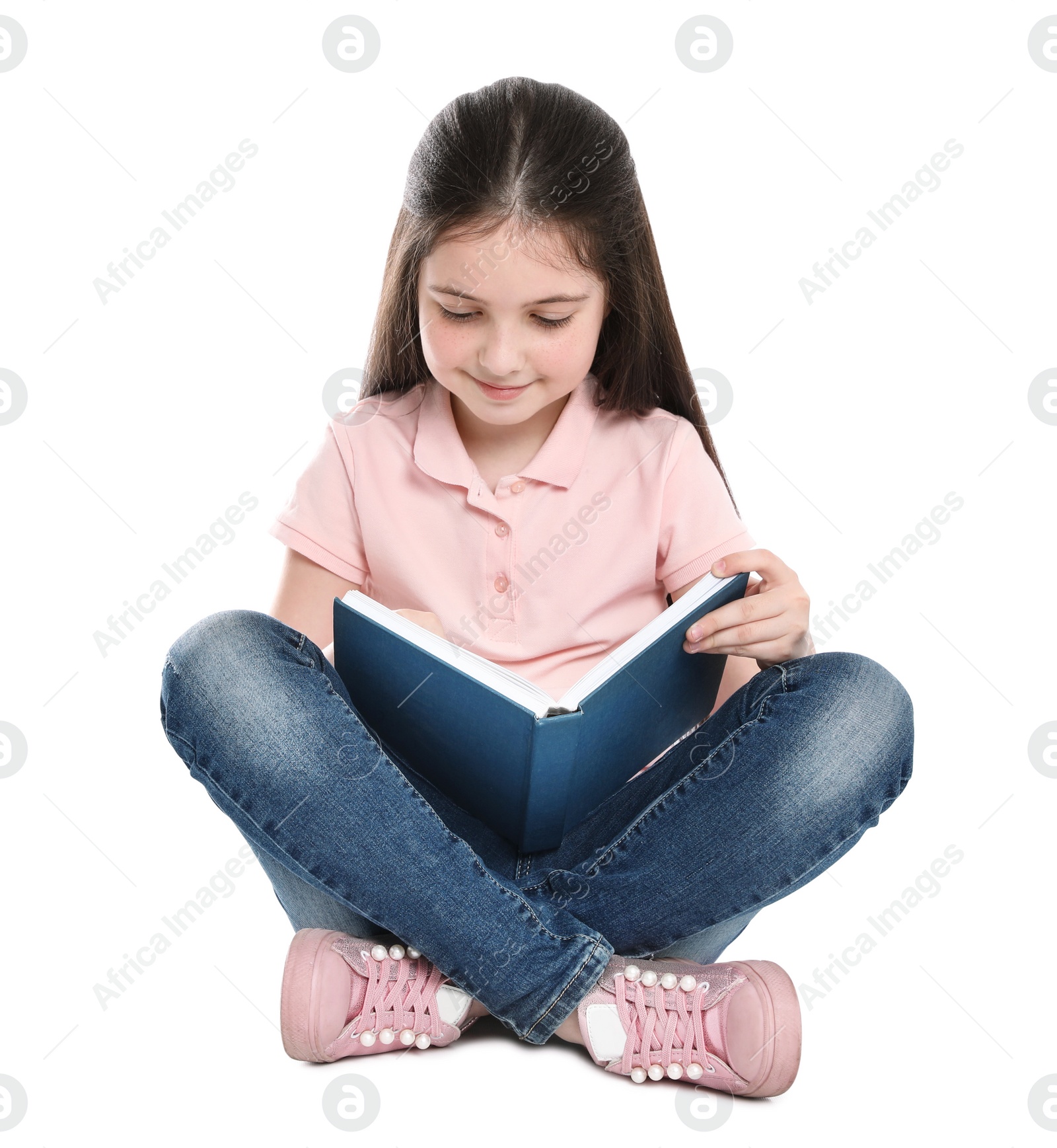 Photo of Cute little girl reading book on white background