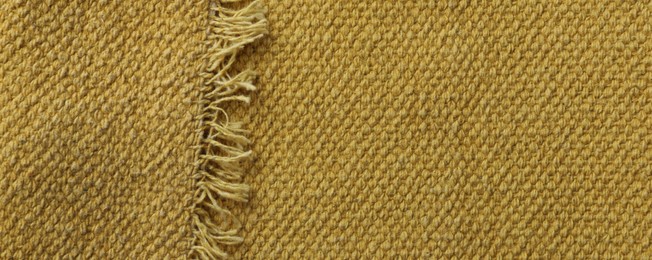 Photo of Texture of golden color fabric as background, top view