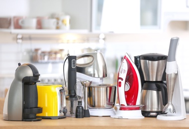 Photo of Household and kitchen appliances on table indoors. Interior element