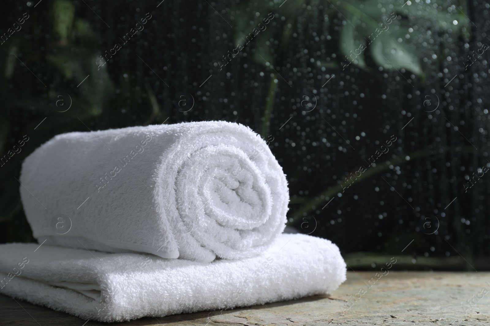 Photo of White terry towels on table in bathroom, space for text