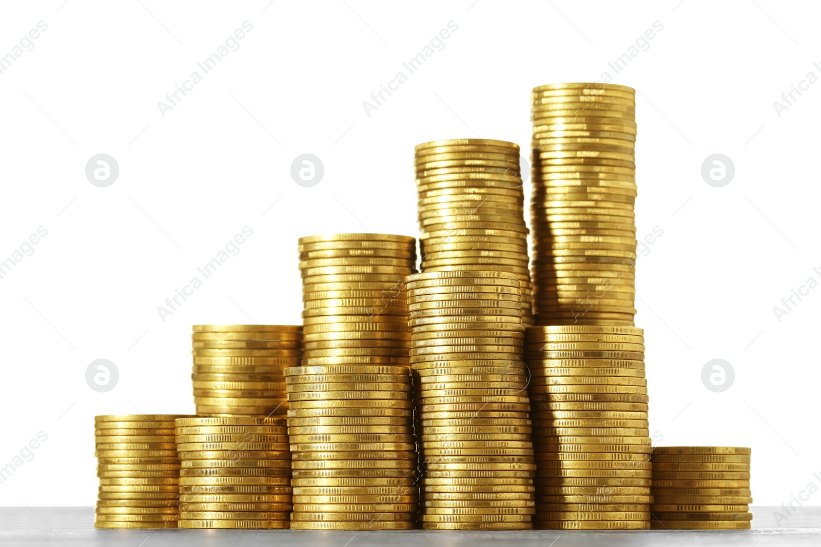 Photo of Stack of coins on wooden table, closeup