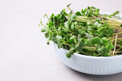 Photo of Fresh organic microgreen on white table, closeup