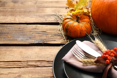 Photo of Festive table setting on wooden background, closeup with space for text. Thanksgiving Day celebration