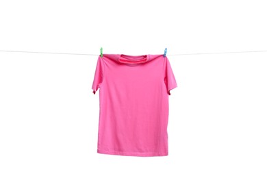 Photo of Pink t-shirt drying on washing line against white background