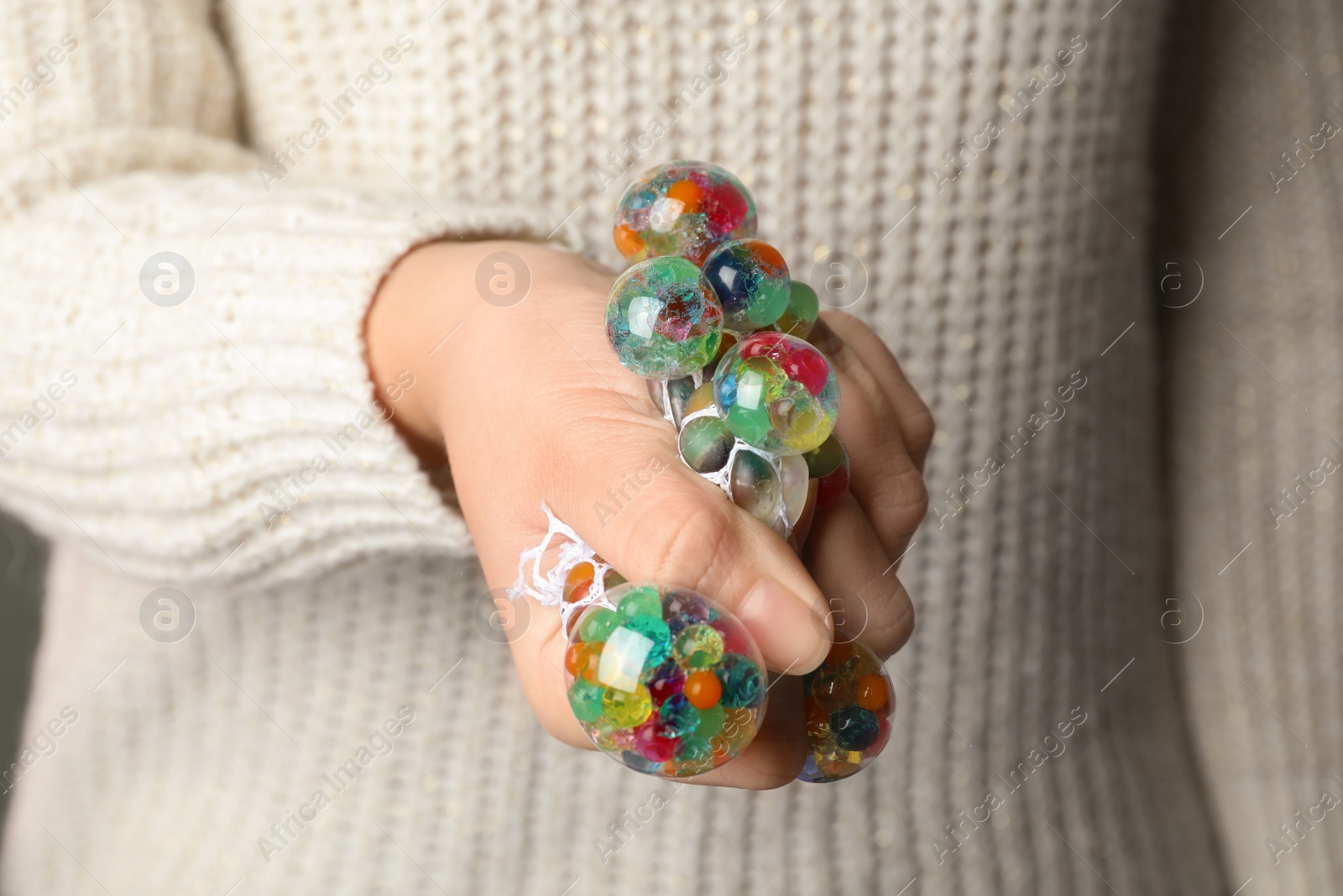 Photo of Woman squeezing colorful slime, closeup. Antistress toy