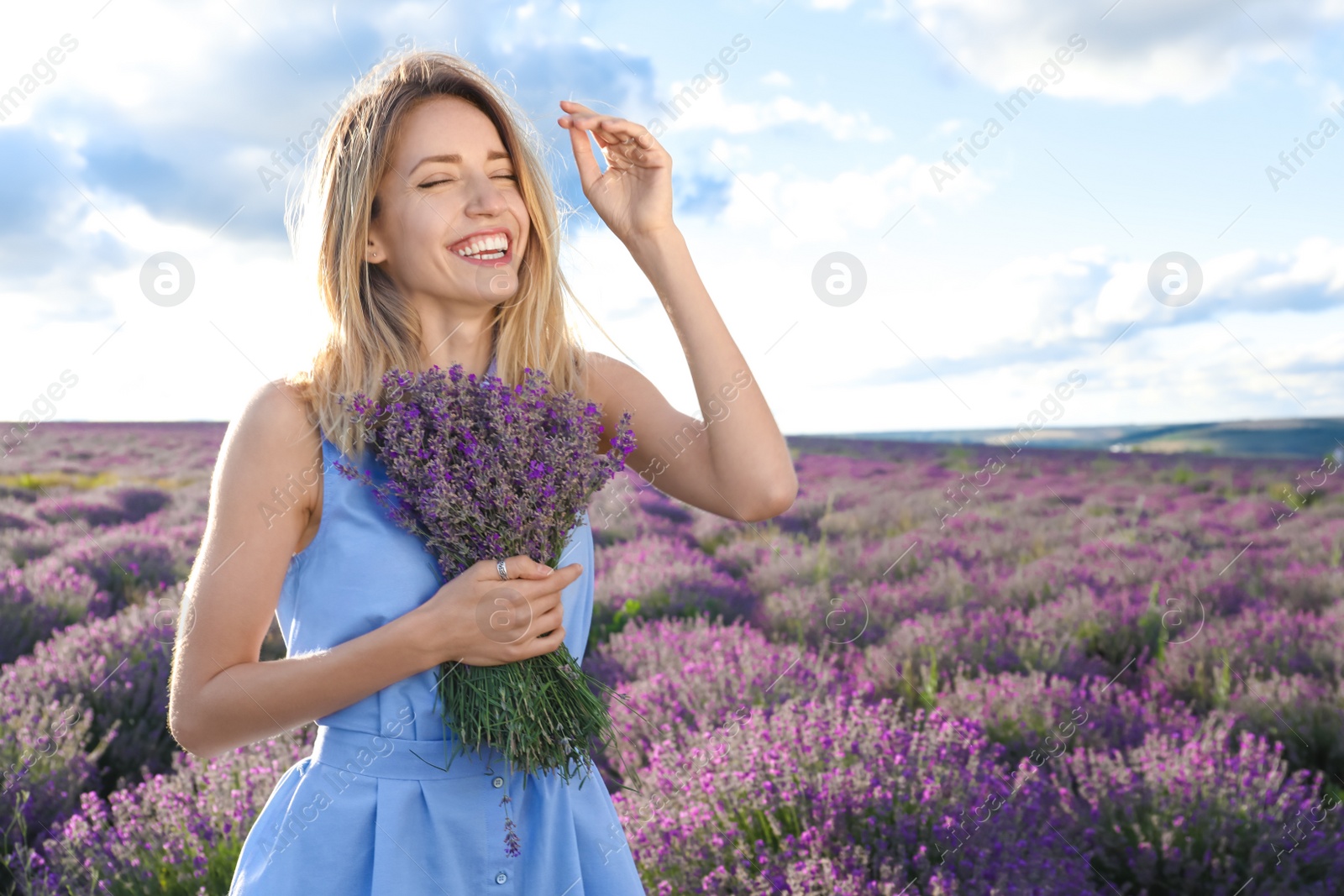 Photo of Young woman with bouquet in lavender field