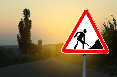 Traffic sign Road Works outdoors at sunrise