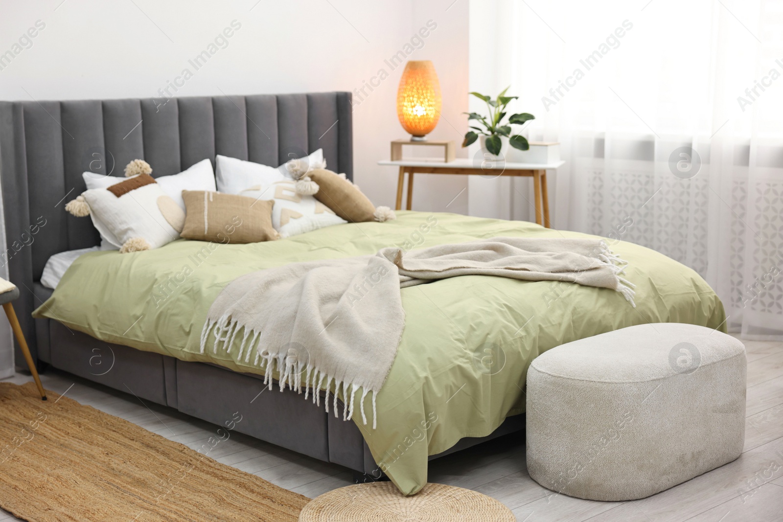 Photo of Soft plaid on bed in stylish bedroom