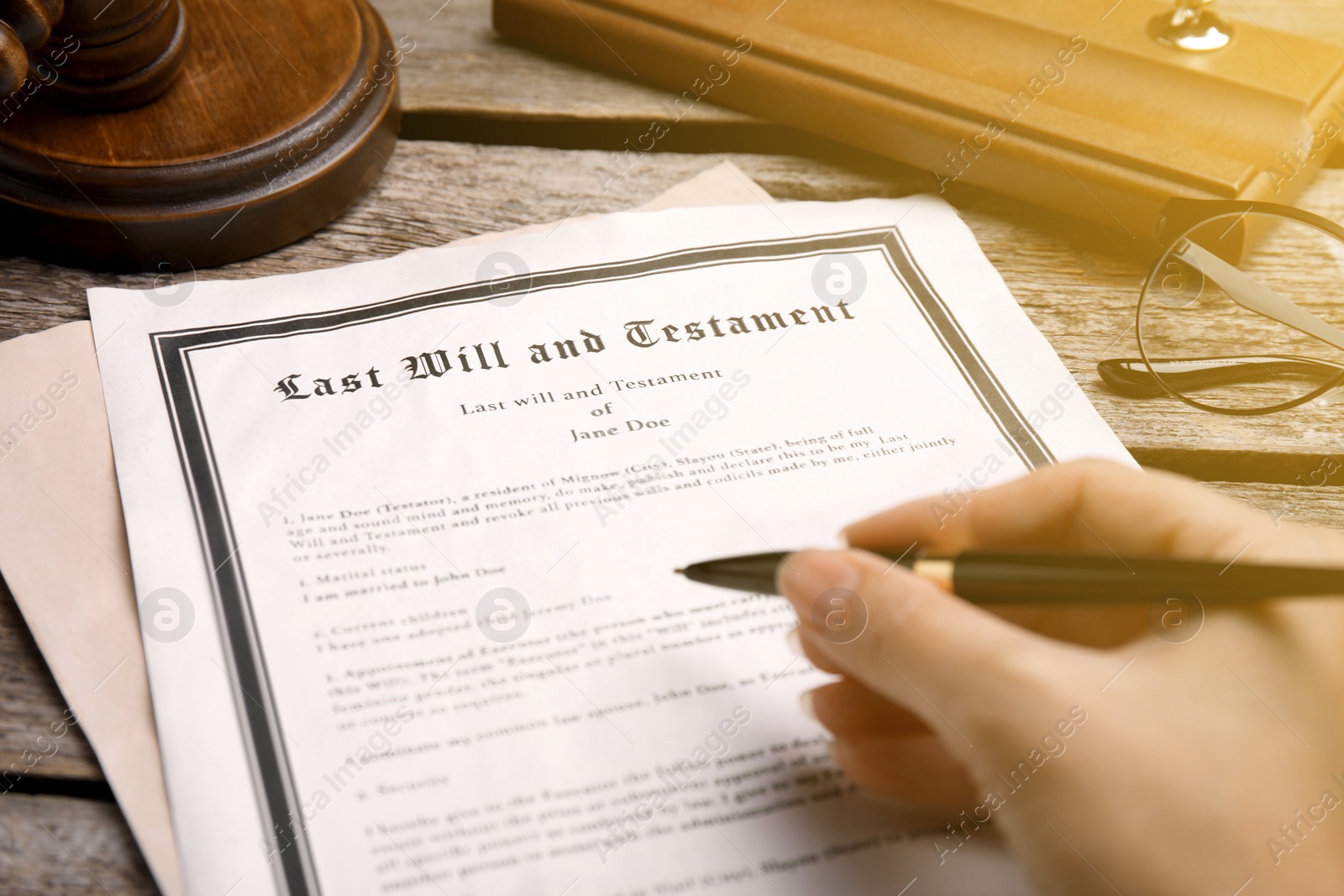 Image of Woman reading Last Will and Testament at wooden table, closeup