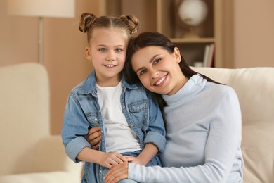 Photo of Little girl with her mother spending time together at home