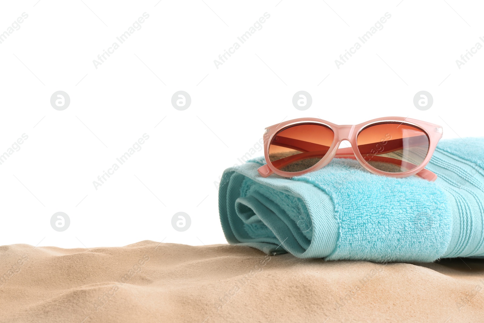 Photo of Composition with beach sand, sunglasses and towel on white background, space for text