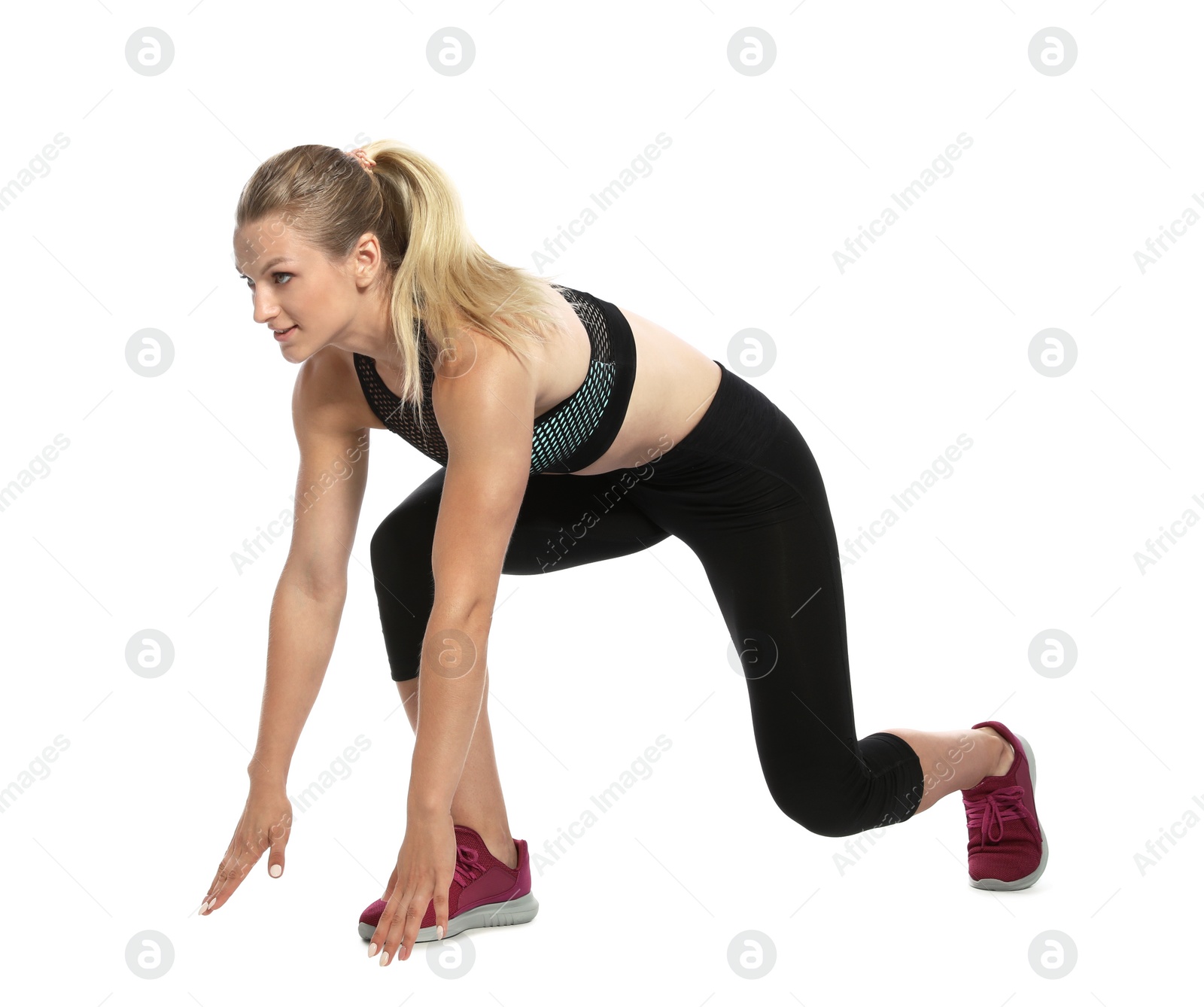 Photo of Young woman ready to run on white background