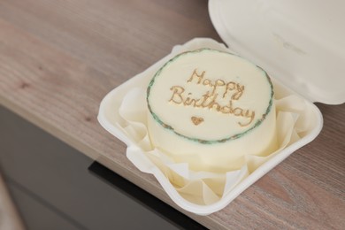 Delicious decorated Birthday cake on wooden surface indoors