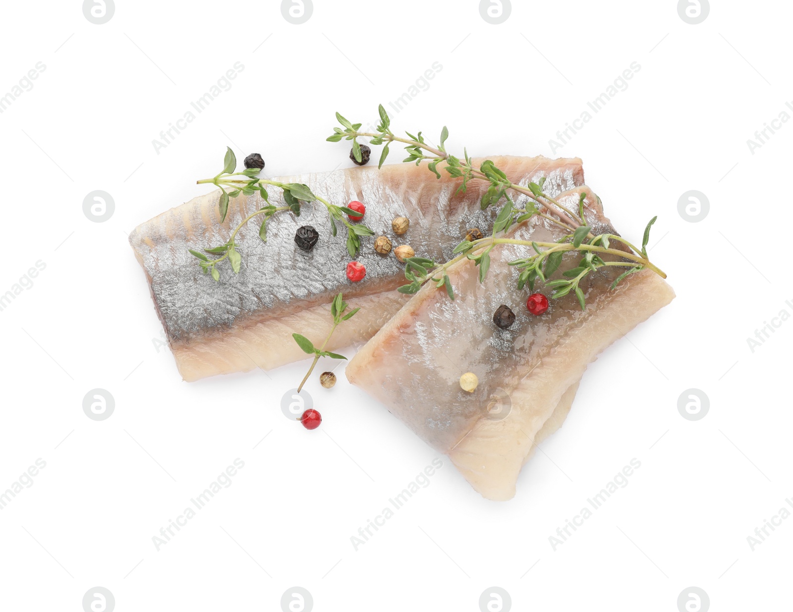 Photo of Delicious salted herring with thyme and peppercorns on white background, top view