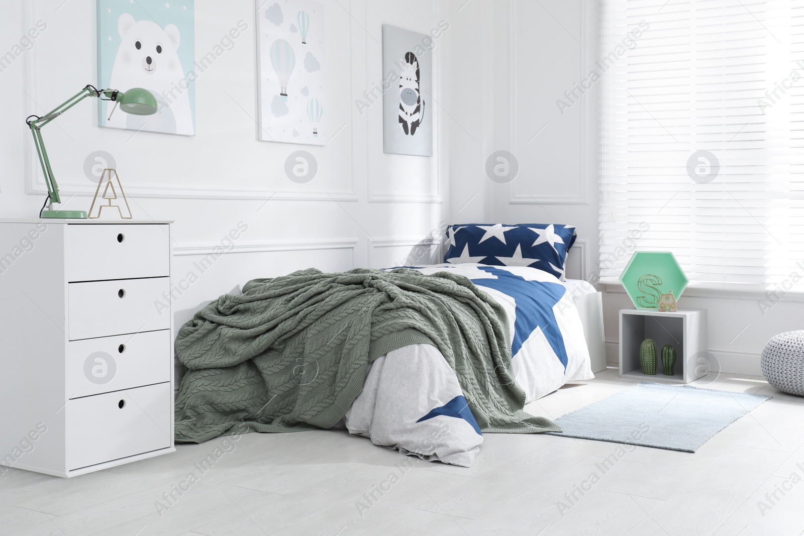 Photo of Bed with stylish linens in children's room