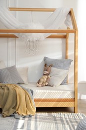 Photo of Stylish child room interior with house bed