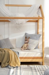 Stylish child room interior with house bed