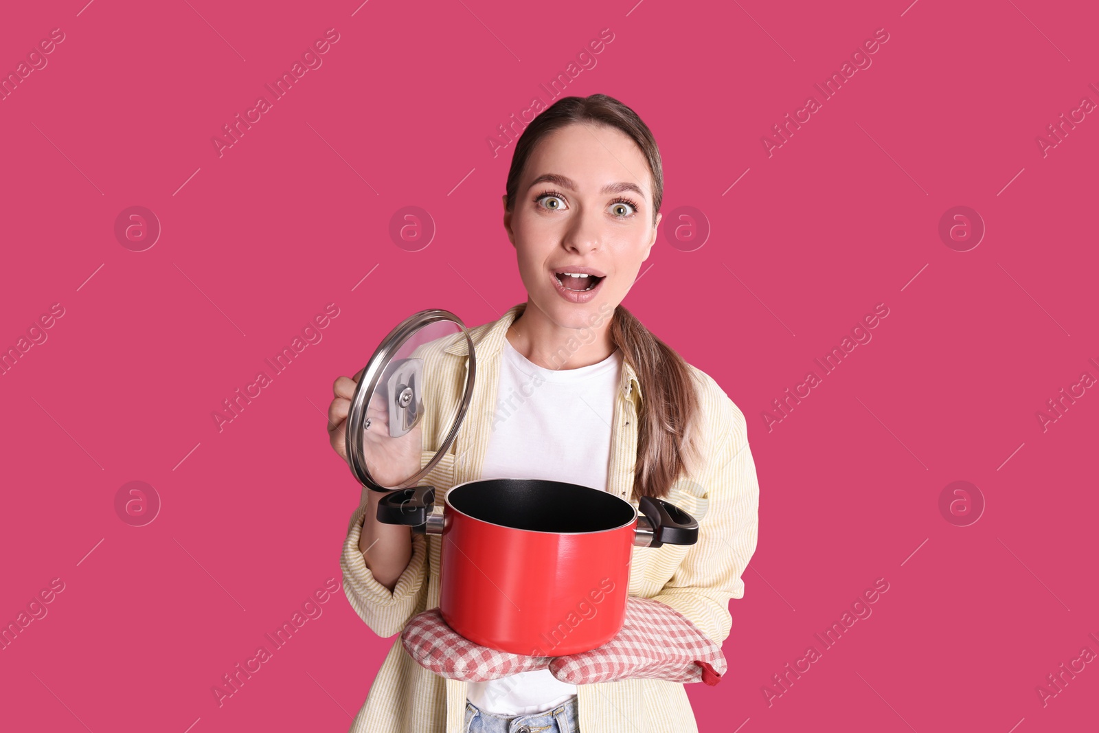 Photo of Surprised woman with pot on crimson background