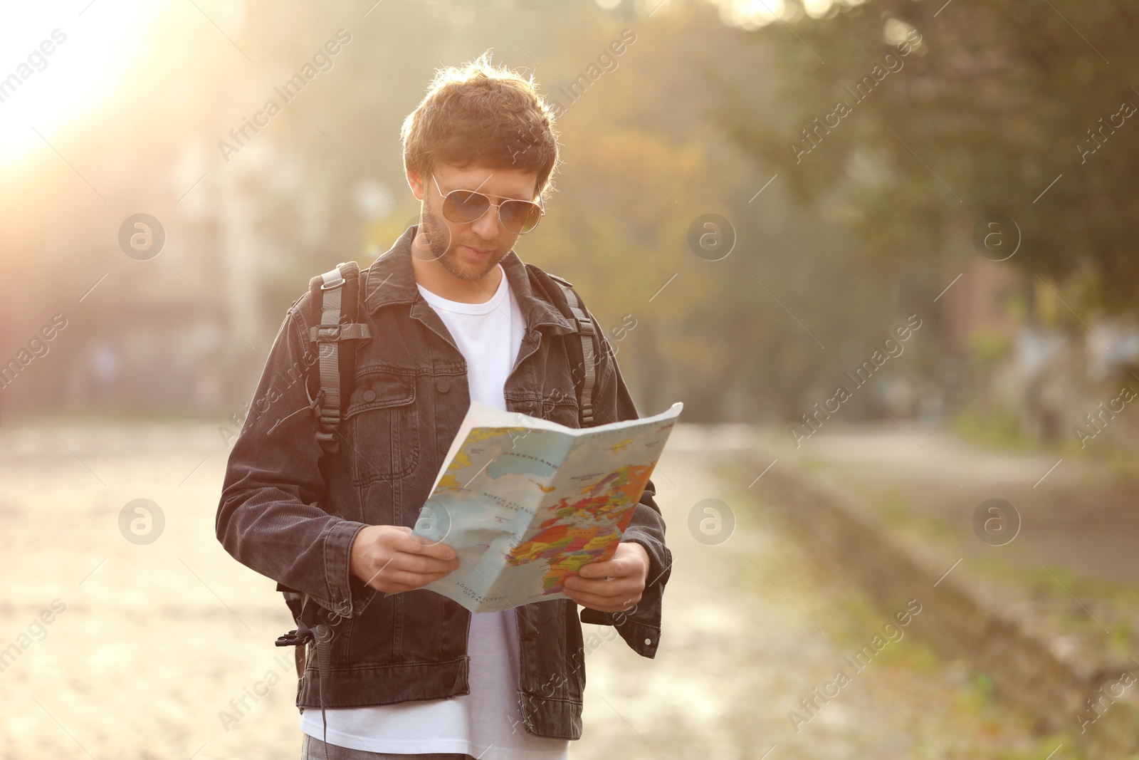 Photo of Traveler with world map on city street