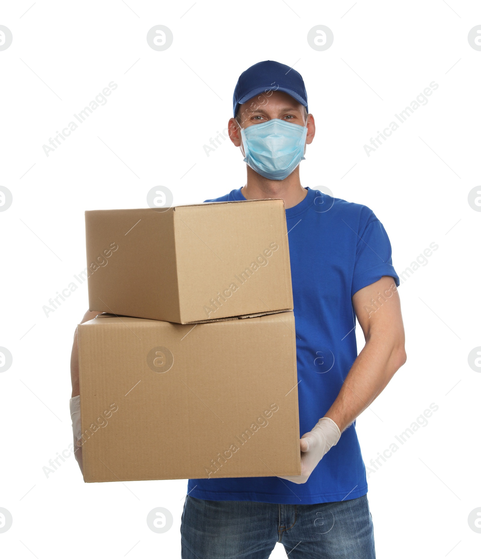 Photo of Courier in protective mask and gloves holding cardboard boxes on white background. Delivery service during coronavirus quarantine