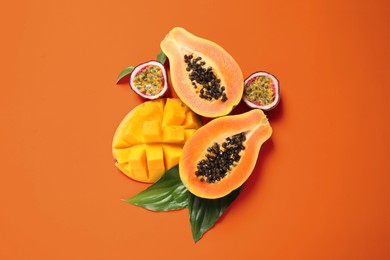 Image of Fresh ripe papaya and other fruits on orange background, flat lay
