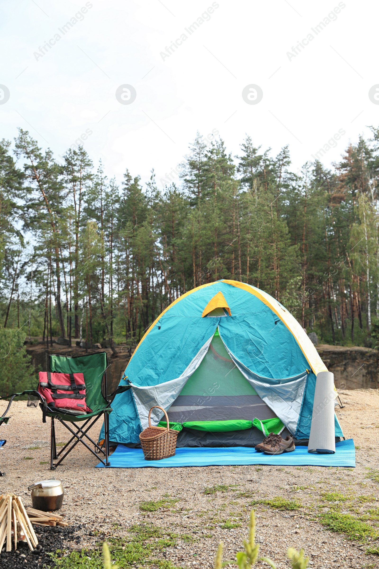 Photo of Camping tent and accessories in wilderness on summer day