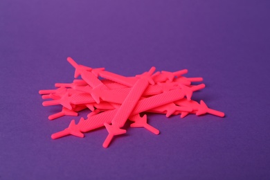 Photo of Pink silicone shoe laces on purple background