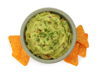 Photo of Bowl of delicious guacamole and nachos chips isolated on white, top view