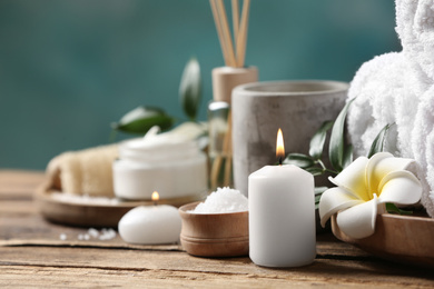 Photo of Beautiful spa composition with plumeria flower on wooden table, closeup