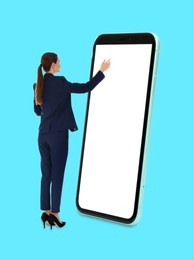 Businesswoman using big smartphone on light blue background