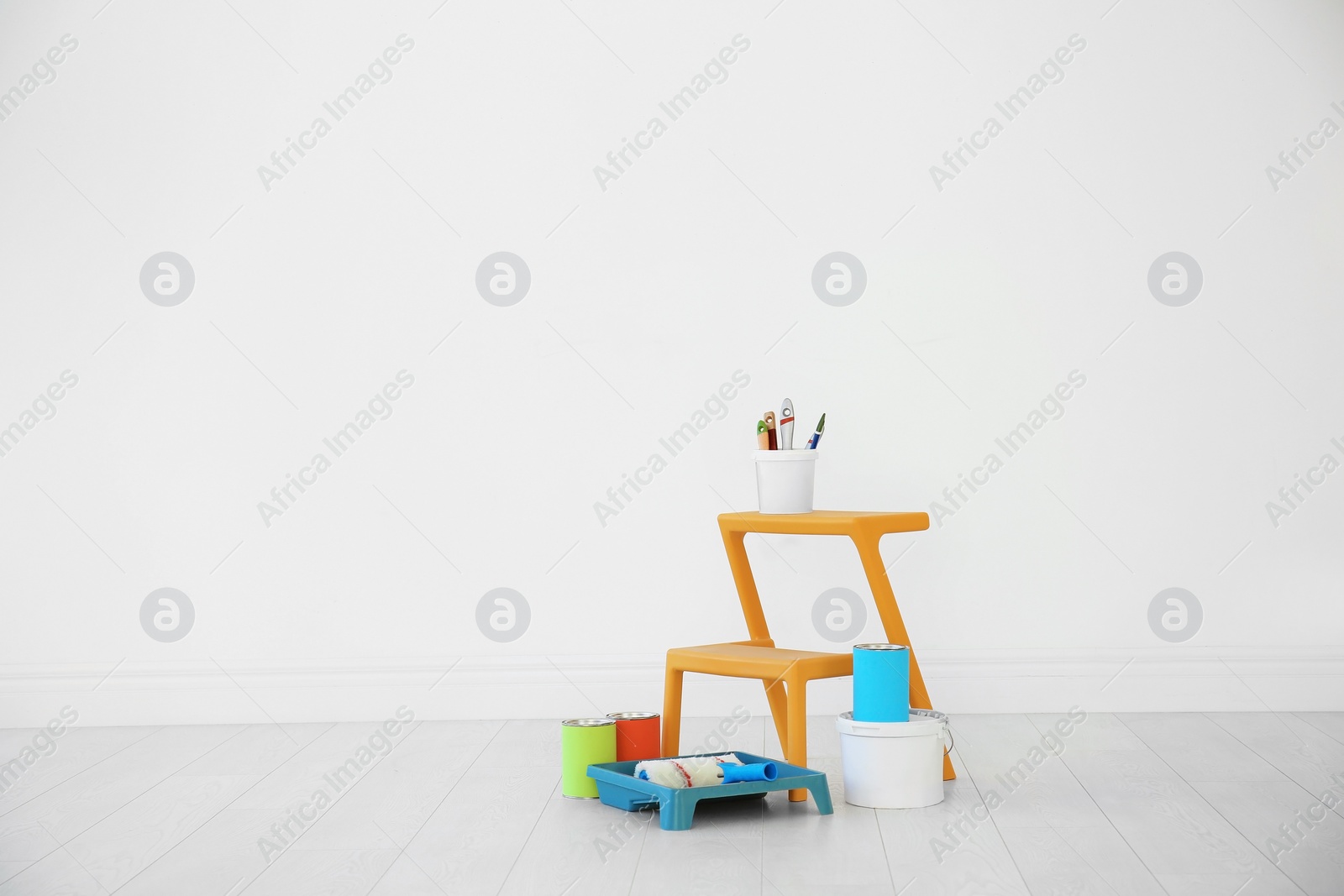 Photo of Decorator's tools near white wall