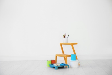 Decorator's tools near white wall