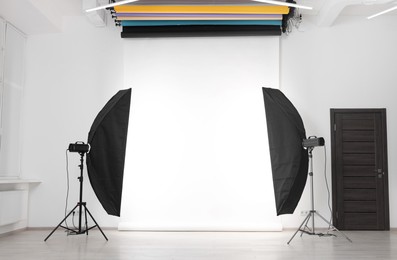 Photo of White photo background and professional lighting equipment in studio