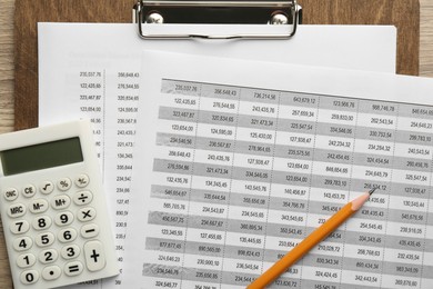 Accounting documents, calculator, clipboard and pencil on table, top view