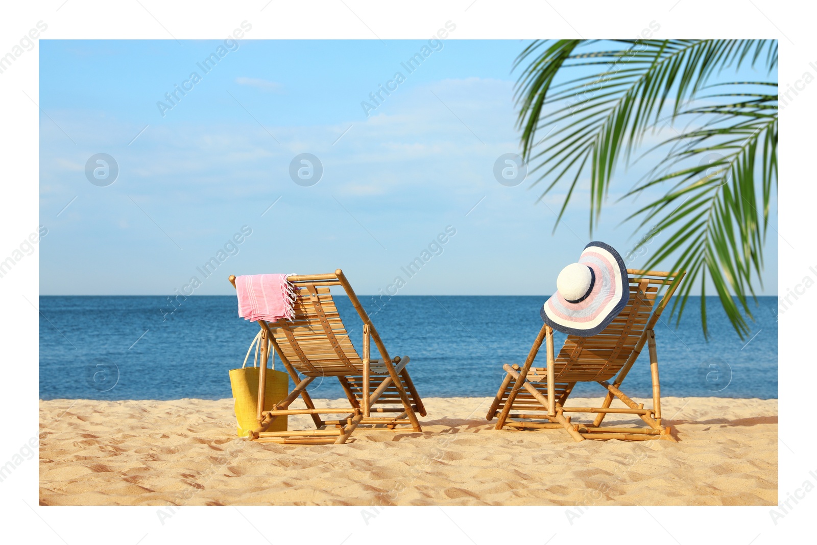 Image of Paper photo. Wooden sunbeds and beach accessories on sandy shore