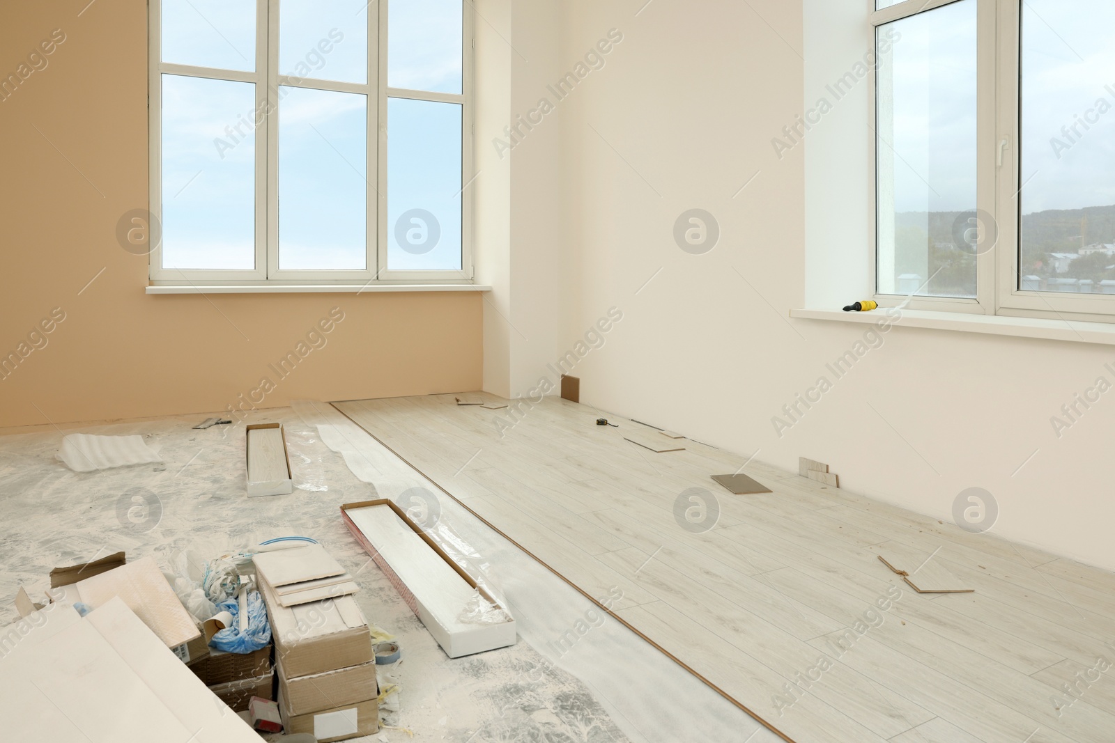 Photo of Light spacious room with unfinished laminate flooring