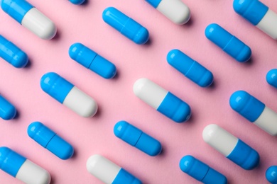 Photo of Many pills on color background, flat lay