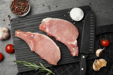 Flat lay composition with fresh raw cut meat on grey table